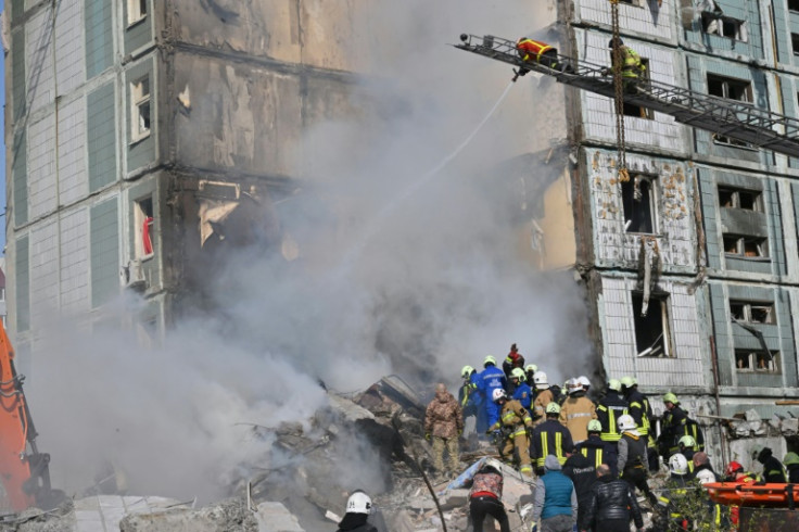 Rescuers search for survivors in the rubble of a residential building in Uman