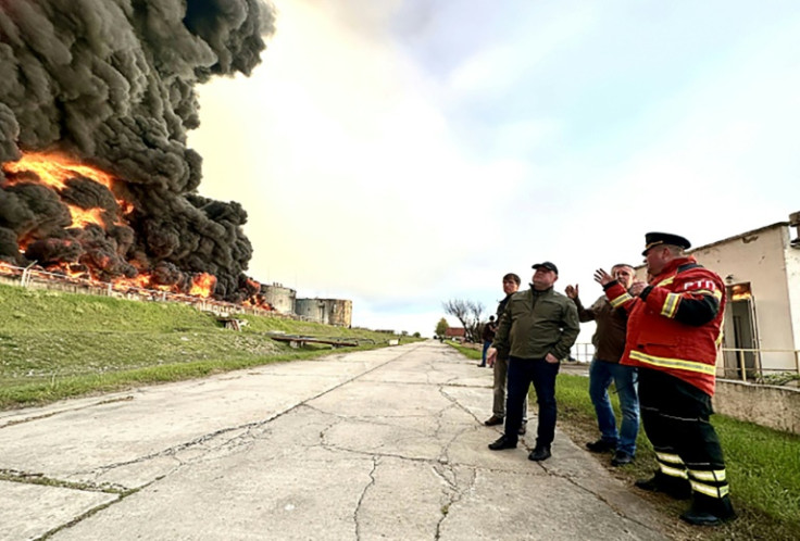 This handout photograph released by the Government of Sevastopol shows firefighters looking at a burning fuel depot in Sevastopol