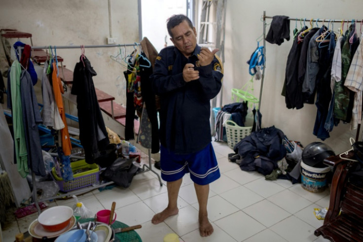 Security guard Srima Sripibal, who earns $13 a day and borrows money each month to get by, wants long-term solutions