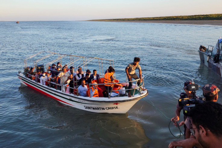 Some Rohingya Muslim refugees and Bangladeshi officials on a boat return after visiting Myanmar's Rakhine State as part of an effort to encourage their voluntary repatriation, in Teknaf