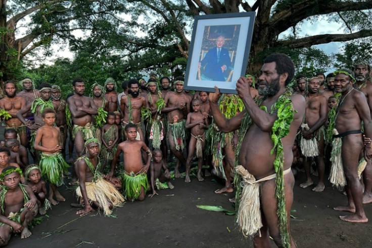 Villagers from Yaohnanen and Yakel on Vanuatu's Tanna island pose with a portrait of Britain's King Charles III on May 6, 2023, ahead of his coronation in London