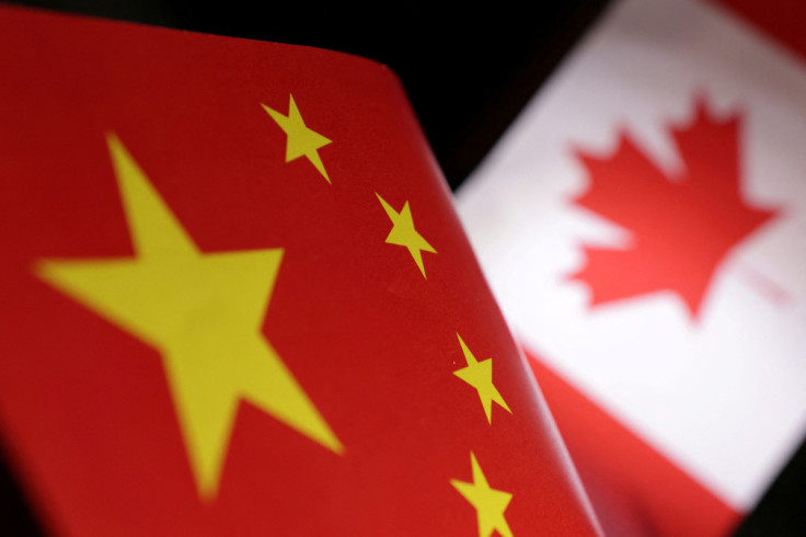 Illustration shows printed Chinese and Canada flags