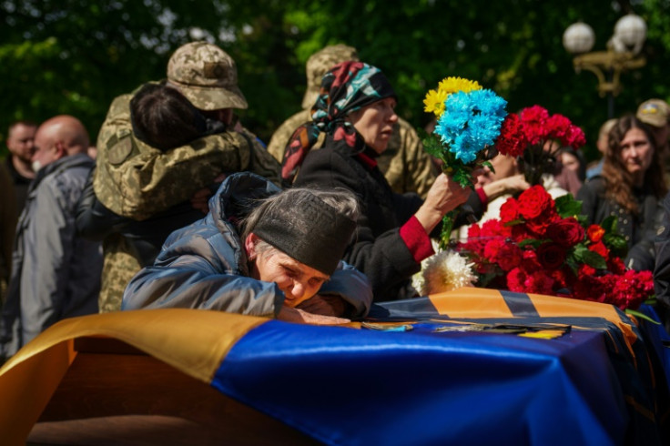 An elderly woman cries over the coffin of Ukrainian serviceman who died near Bakhmut
