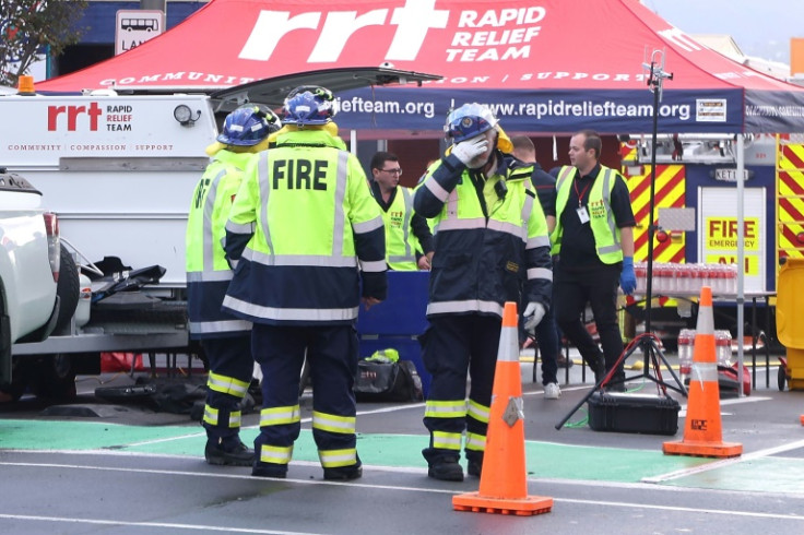 Emergency responders work outside the Loafers Lounge hostel in Wellington, where at least six people were killed in a fire on Tuesday