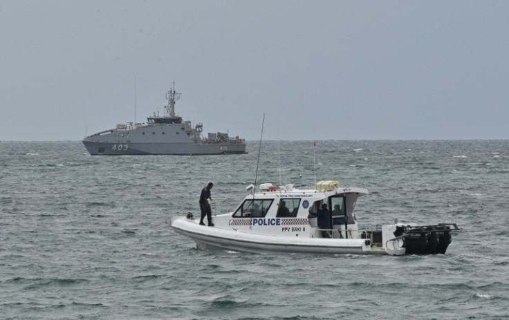 Police patrol near APEC Haus in Port Moresby where India's leader and the United States' top diplomat are meeting Pacific leaders