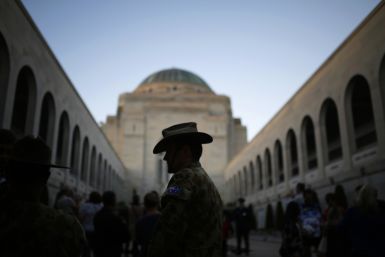 An Australian soldier in pictured in front of the Tomb of the Unknown Soldier at dusk on the eve of ANZAC Day in Canberra