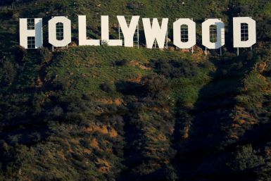 The iconic Hollywood sign is shown on a hillside above a neighborhood in Los Angeles